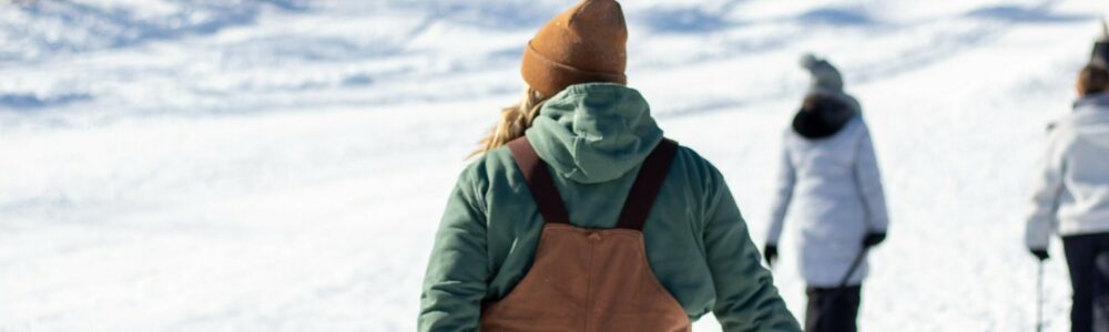 Person dragging a snow-tube up hill
