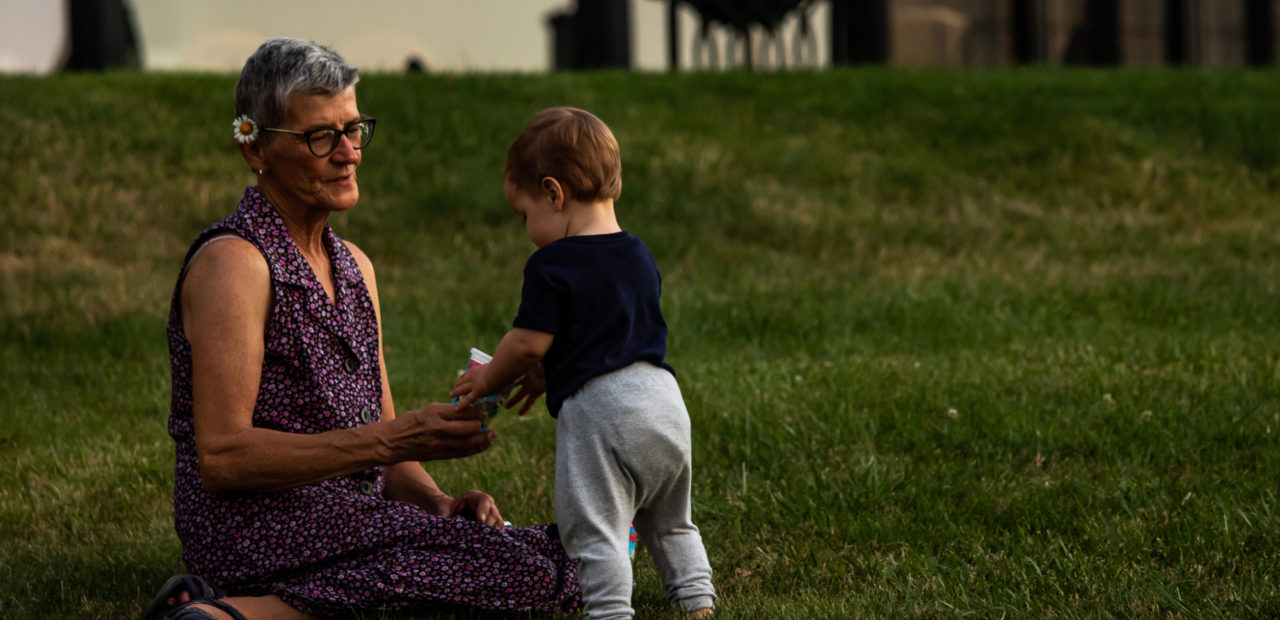 Grandmother playing with her grandson in the yard