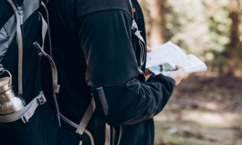 Hiker looking at a trail guide