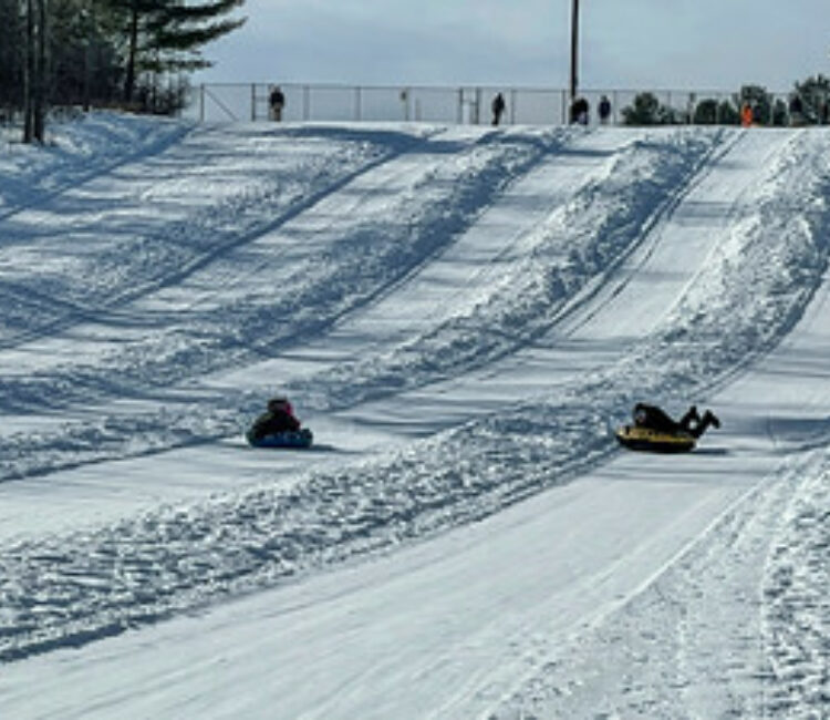 Sledding down a snowy hill