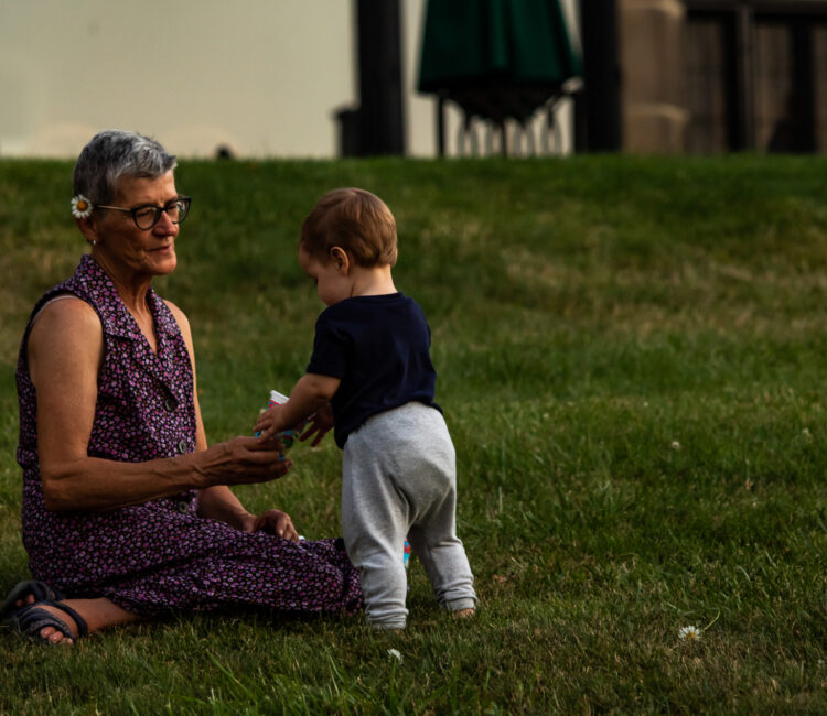 Grandmother playing with her grandson in the yard