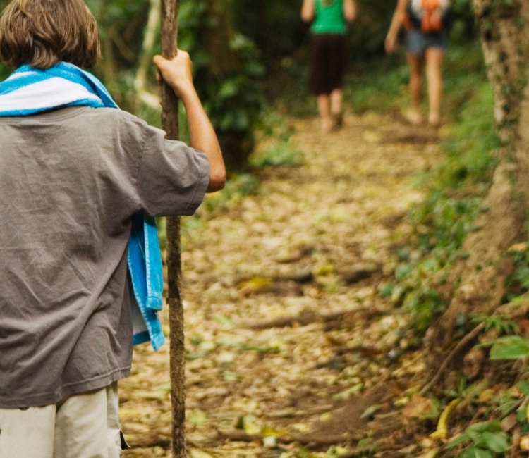 Kid walking with a hiking stick