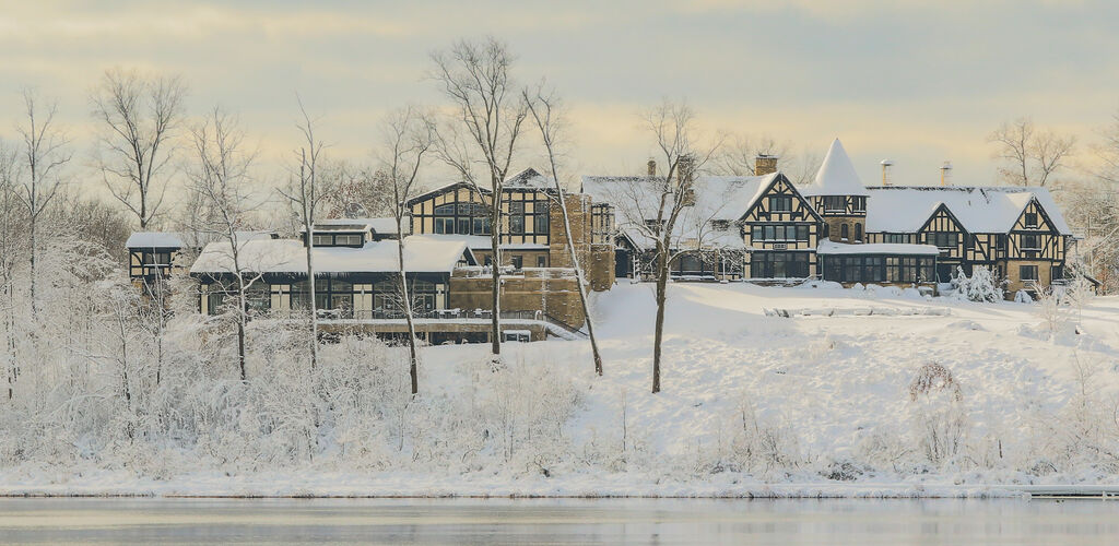 Punderson Manor exterior with frozen lake during winter