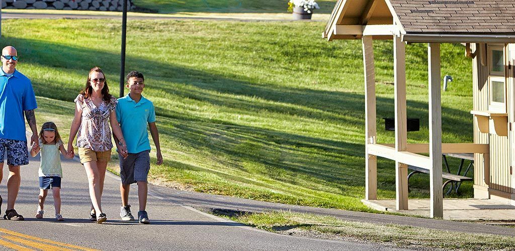 Two people walking by the cabins