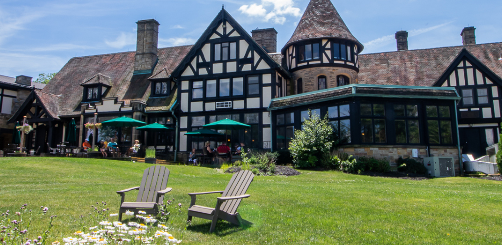 Punderson Manor exterior with families under umbrellas